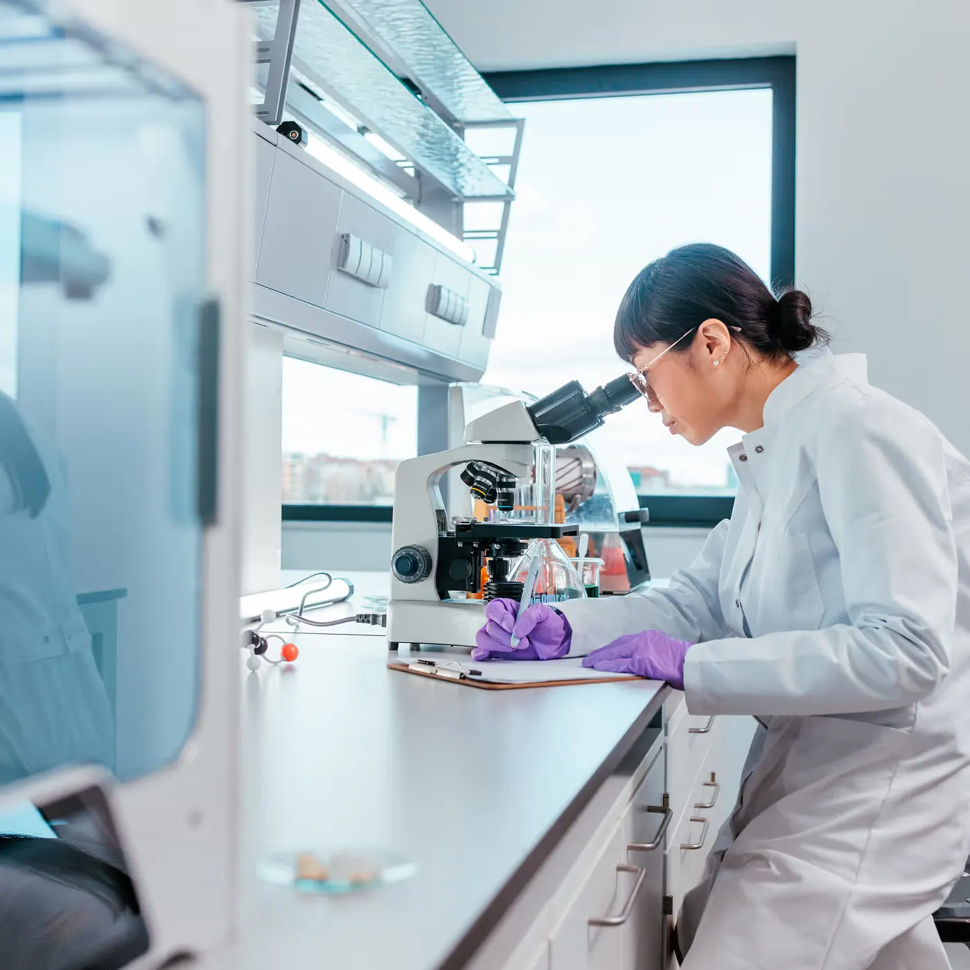Scientist at a lab bench in a hospital research area protected by facial authentication access control