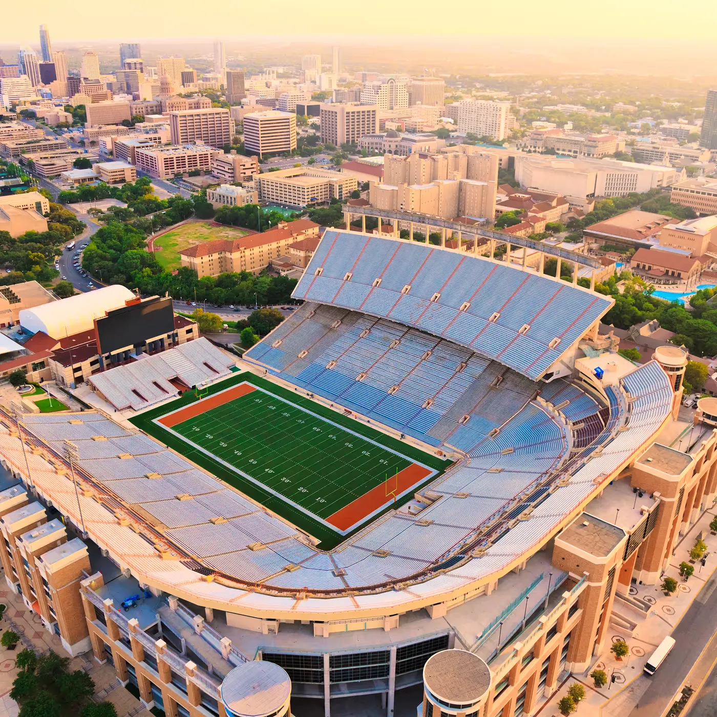 Aerial view of a packed stadium at sunset with facial authentication securing player and staff entrances
